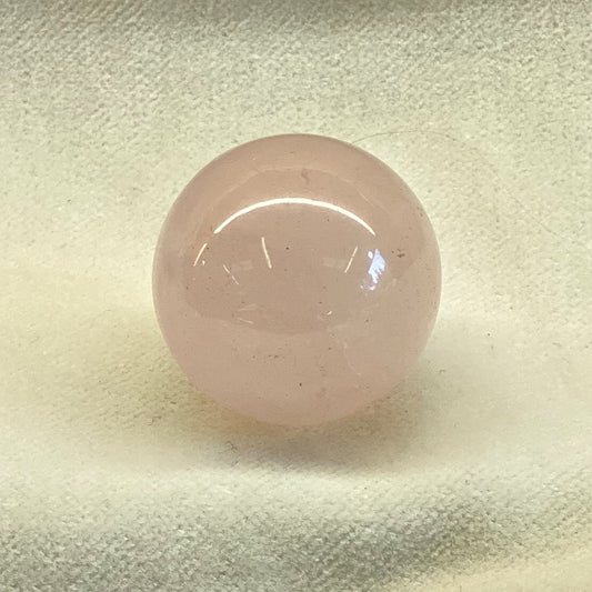 Rose Quartz Sphere.  Perfect orb in a nice pink hue.  Size: 3/4 inch.   Rose Quartz folk lore says that rose quartz attracts love.