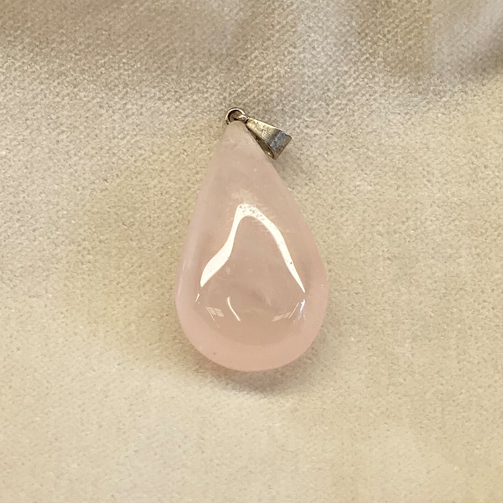 Rose Quartz Teardrop Pendant.  Sweet petite pale pink stone.  Great shape.  Nice polish and very translucent.  Average pendant size is 1 1/4 inch.  Rose quartz is said to be the stone that attracts LOVE.