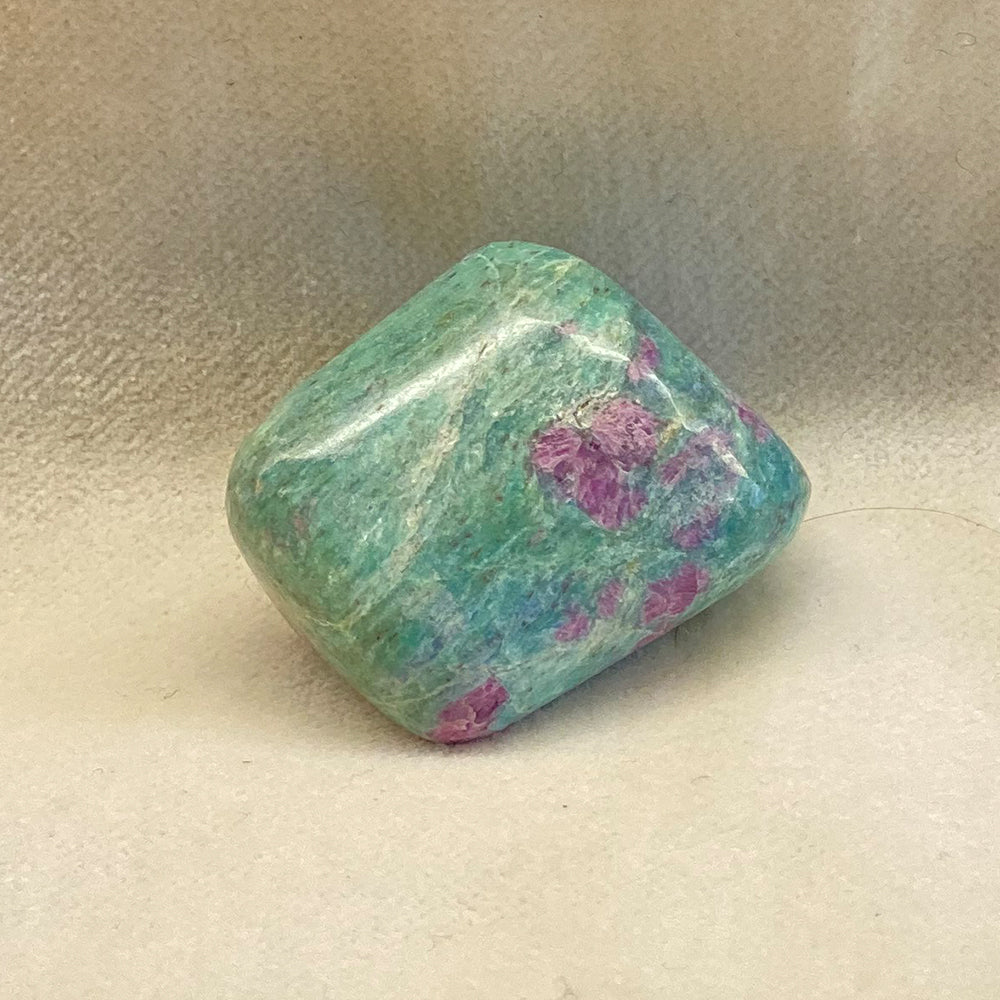 Ruby in Fuchsite Tumbled Nugget.  Green Fuchsite with beautiful Red Ruby, with occasional bluish Kyanite striations.  Smooth and bright tumble polish.  Size: about 1 inch.  This stone is said to facilitate communication within ones self and with others.